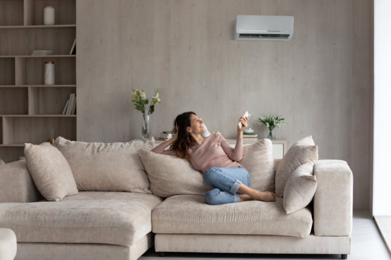 Woman sitting on couch.
